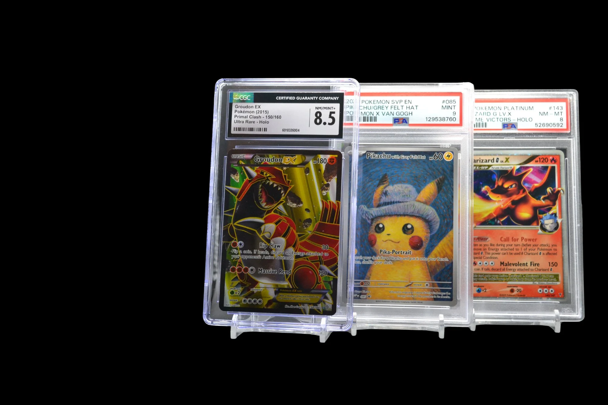 Three graded Pokémon slabs — PSA and CGC
